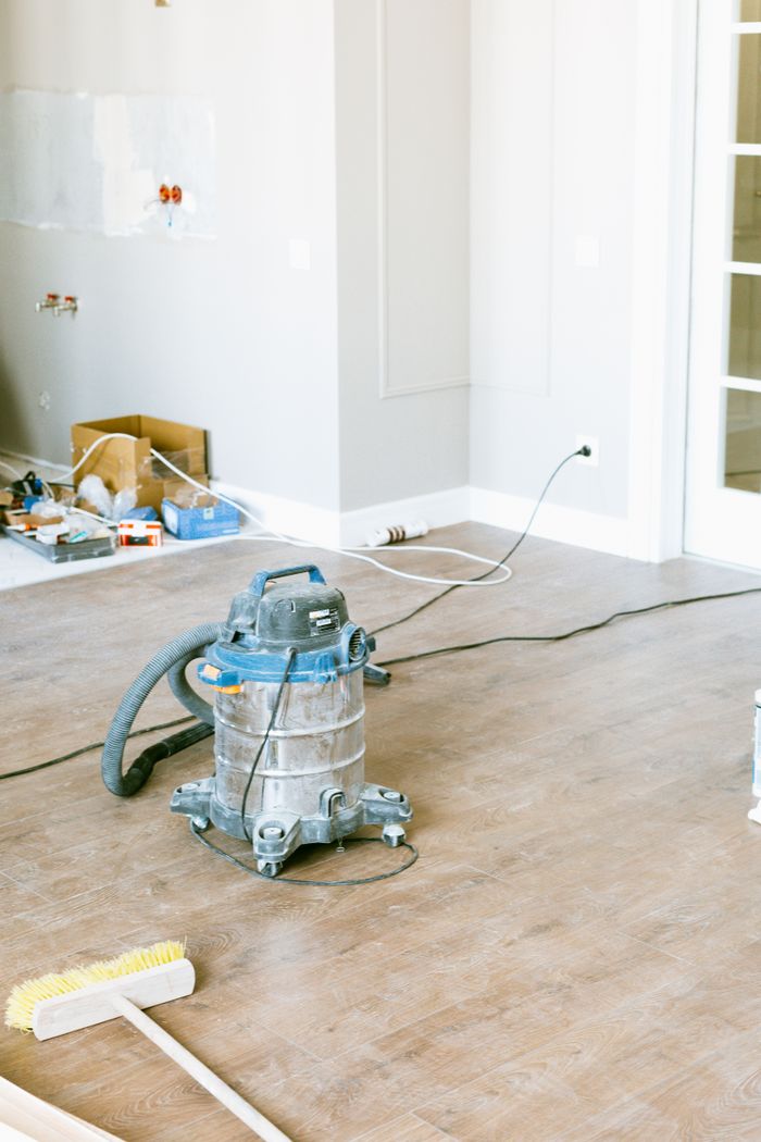 services-03 Vacuum and tools in a room undergoing renovation, showcasing home improvement.